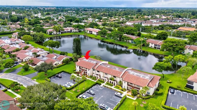 an aerial view of a houses with a lake view