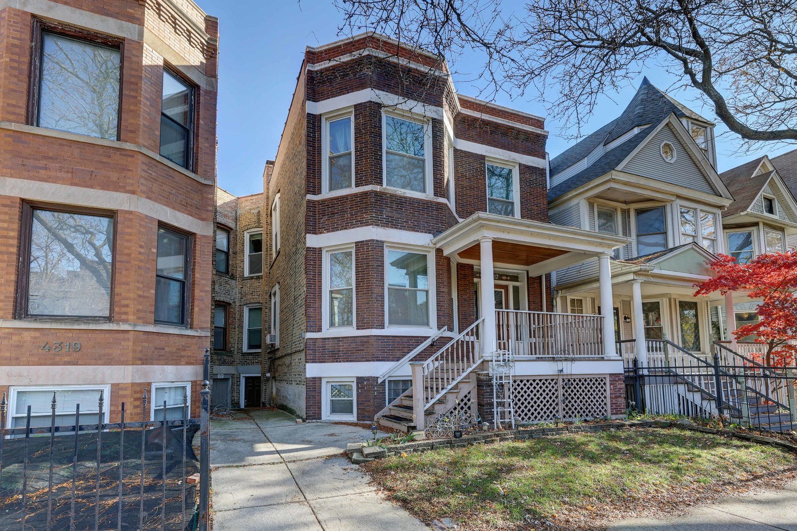 a front view of a residential apartment building with a yard