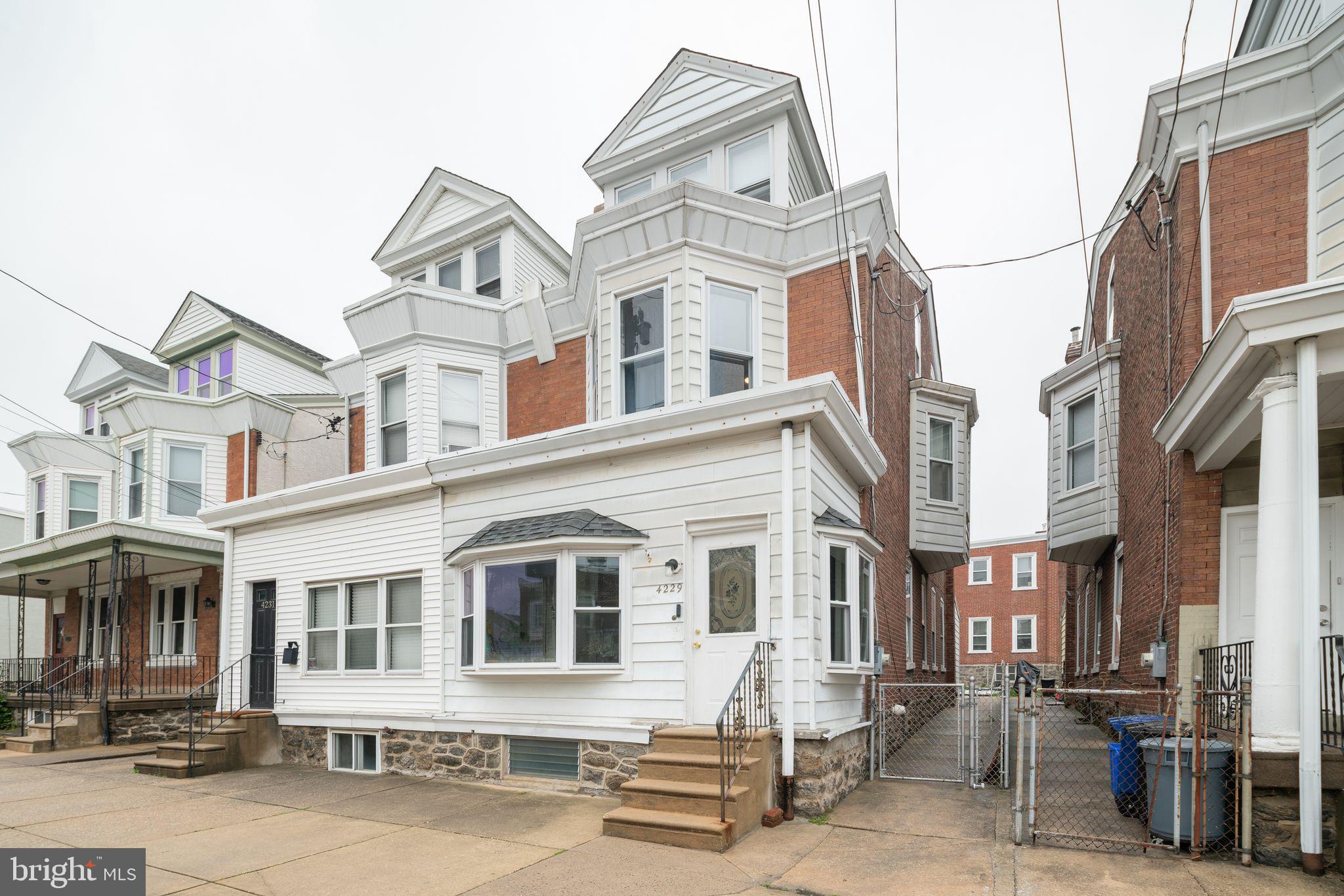 a front view of a residential apartment building with a yard