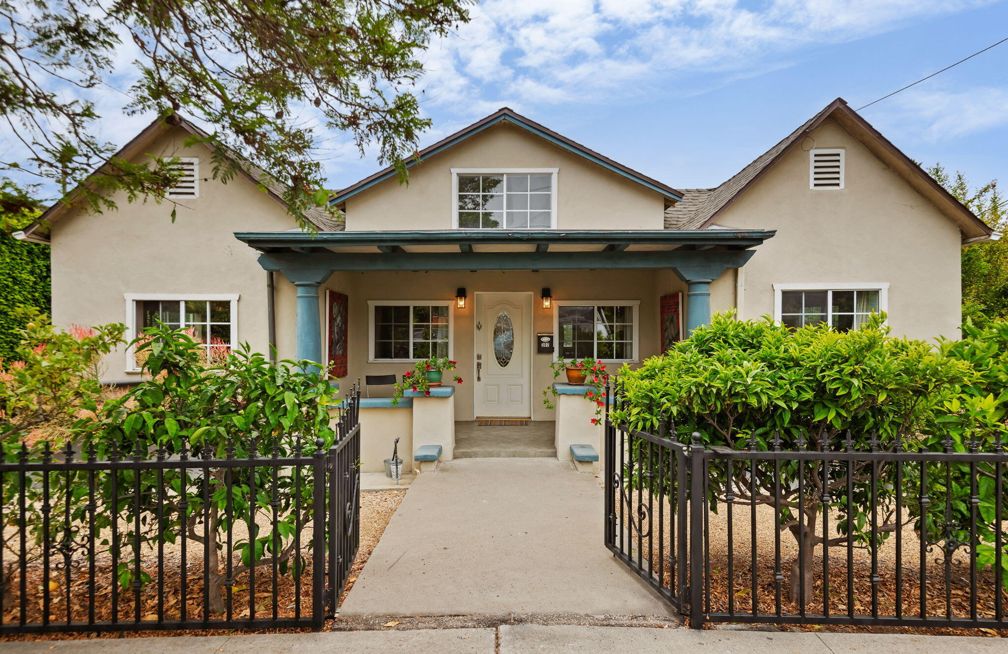 a front view of a house with a garden