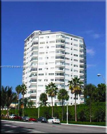 a view of a tall building with a yard