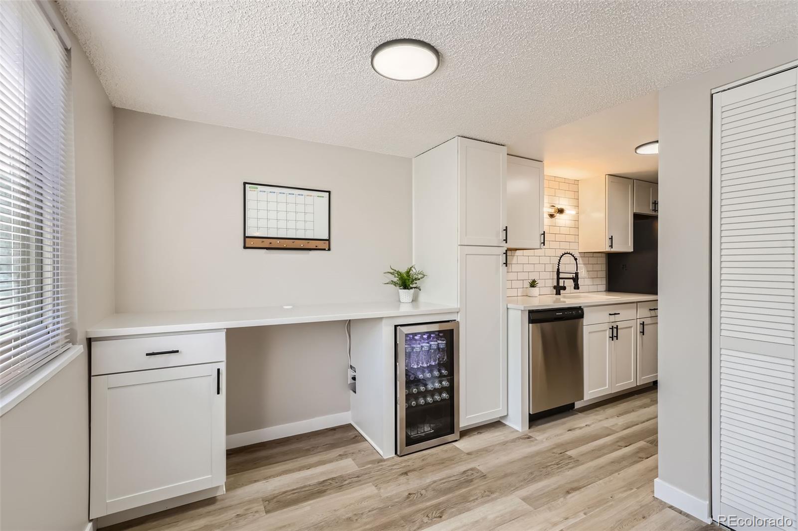 a kitchen with cabinets and stainless steel appliances