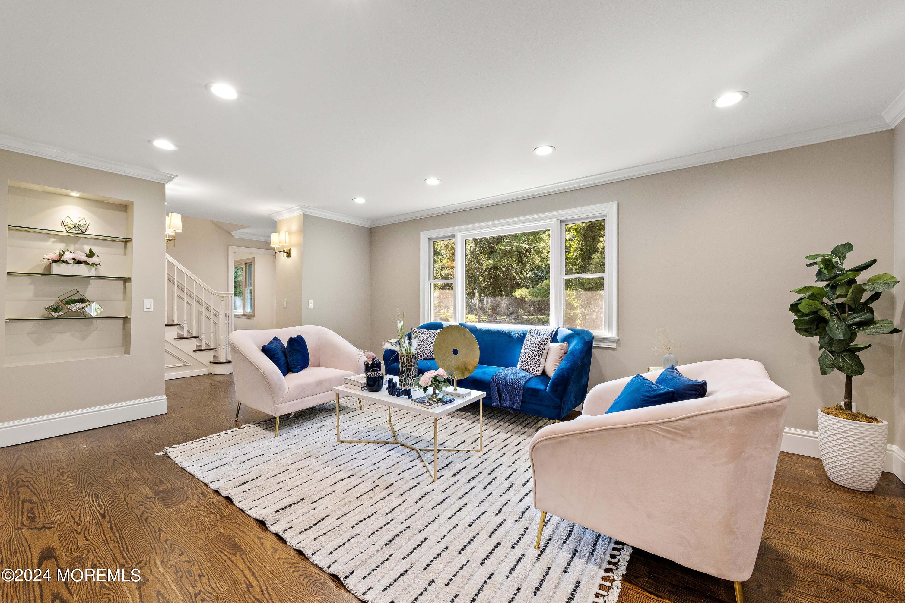 a living room with furniture wooden floor and window