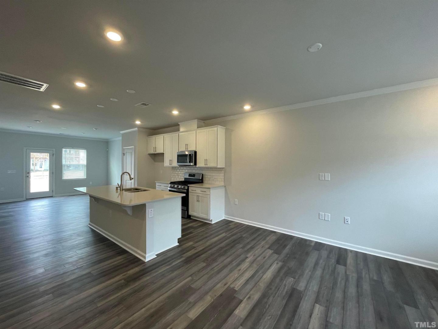 a view of kitchen with cabinets and wooden floor