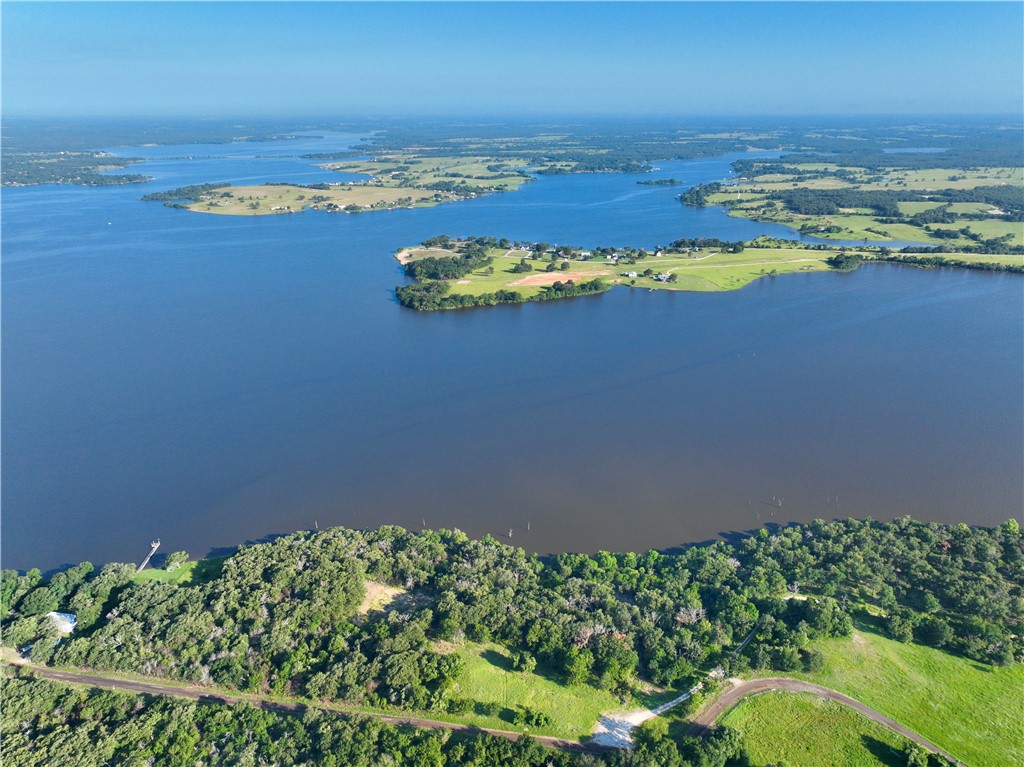 an aerial view of a house with a lake view