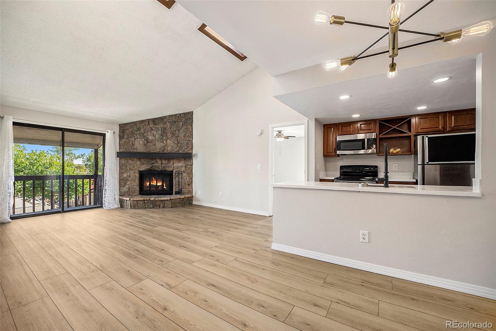 a view of a kitchen with a sink and a fireplace