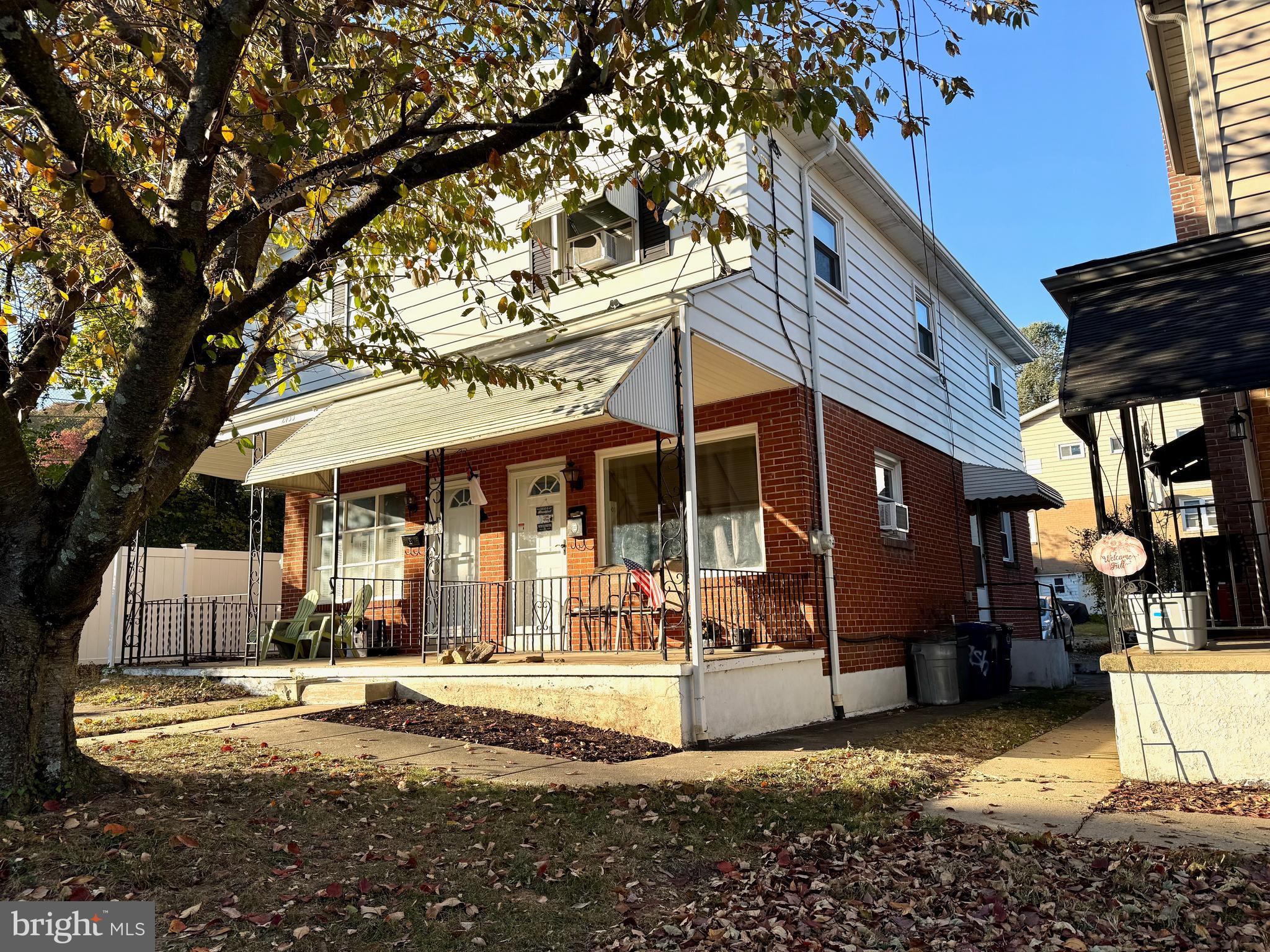 a view of a house with a yard and sitting area