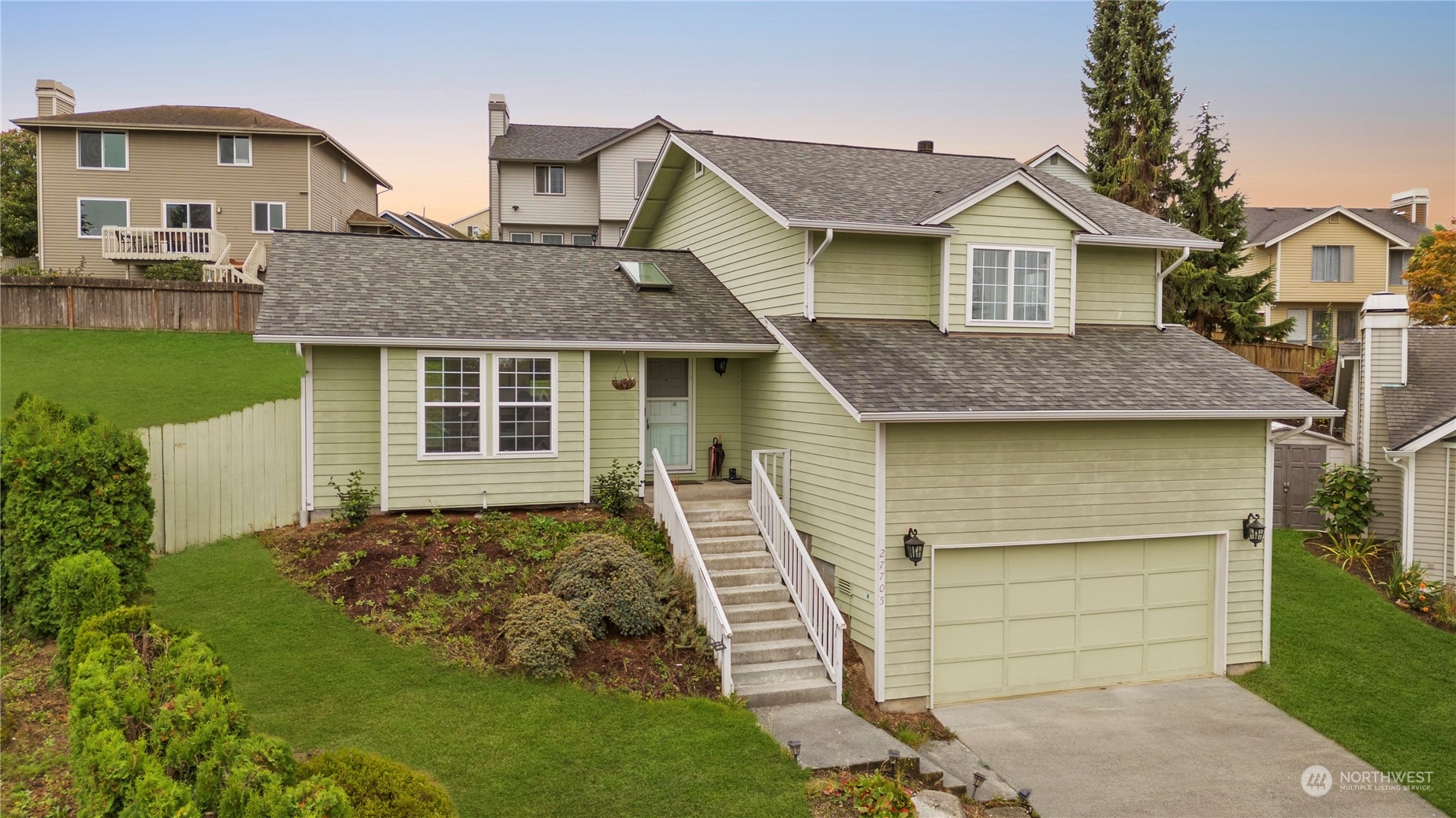 a front view of a house with a garden