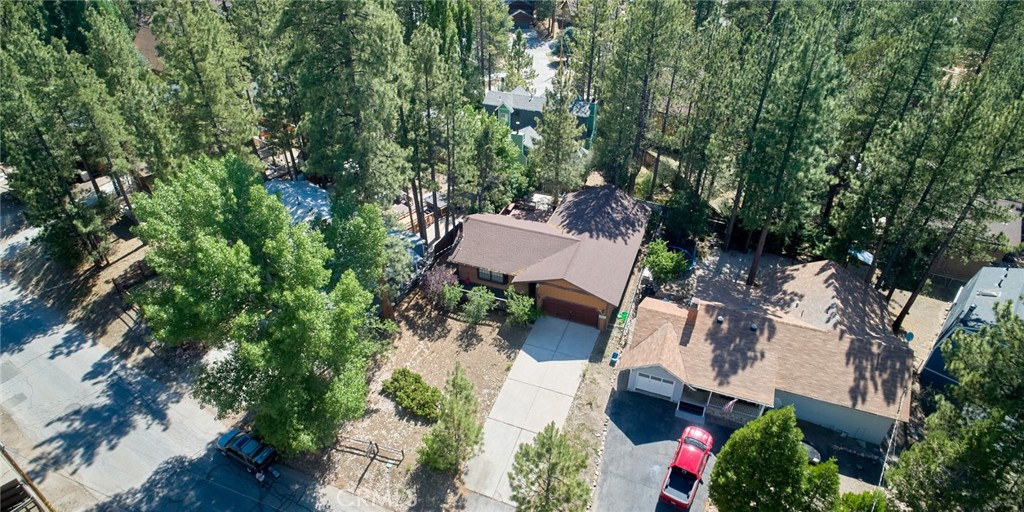 an aerial view of a house with yard and outdoor seating