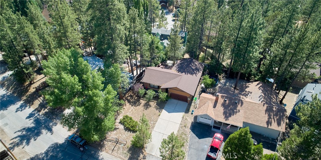 an aerial view of a house with yard and outdoor seating