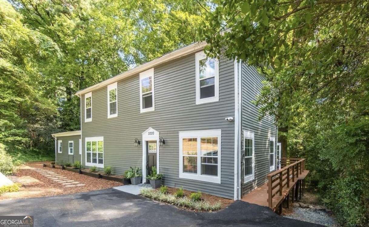 a view of a house with a tree front of house