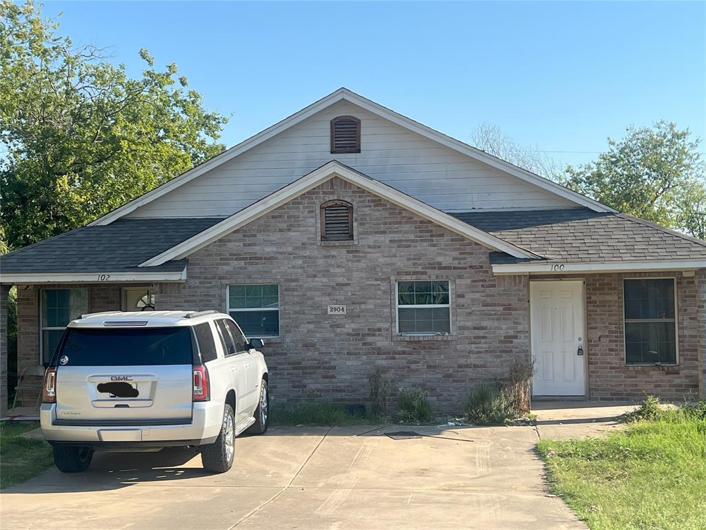 a front view of a house with parking