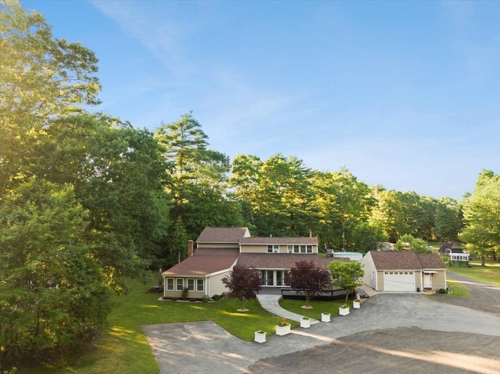 a aerial view of a house with a yard and balcony