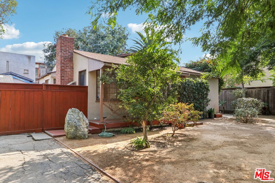 a backyard of a house with plants and trees