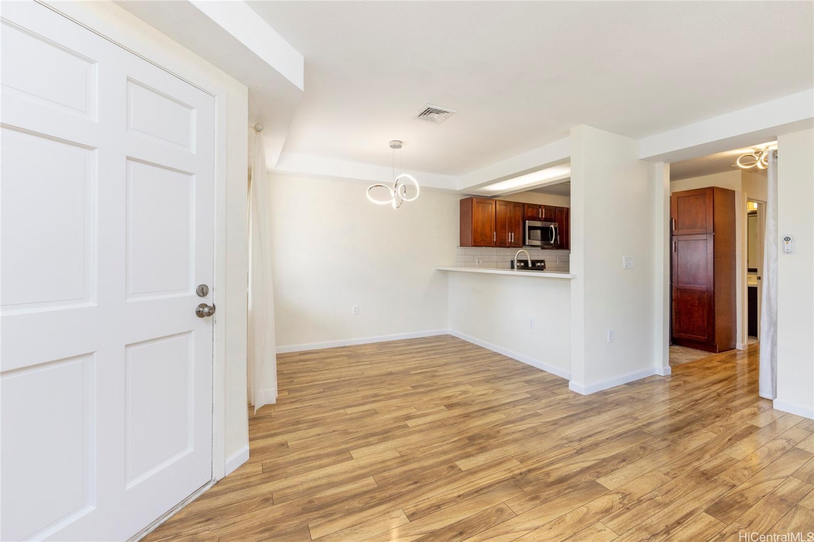 a view of a livingroom with wooden floor and closet