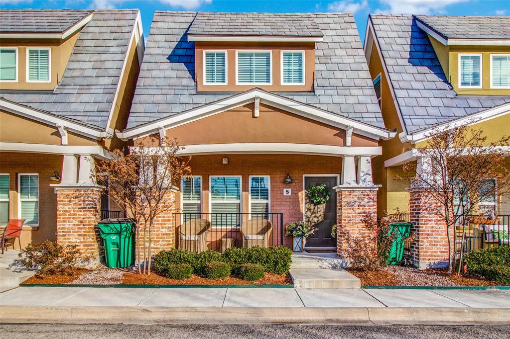 front view of a brick house with a small yard