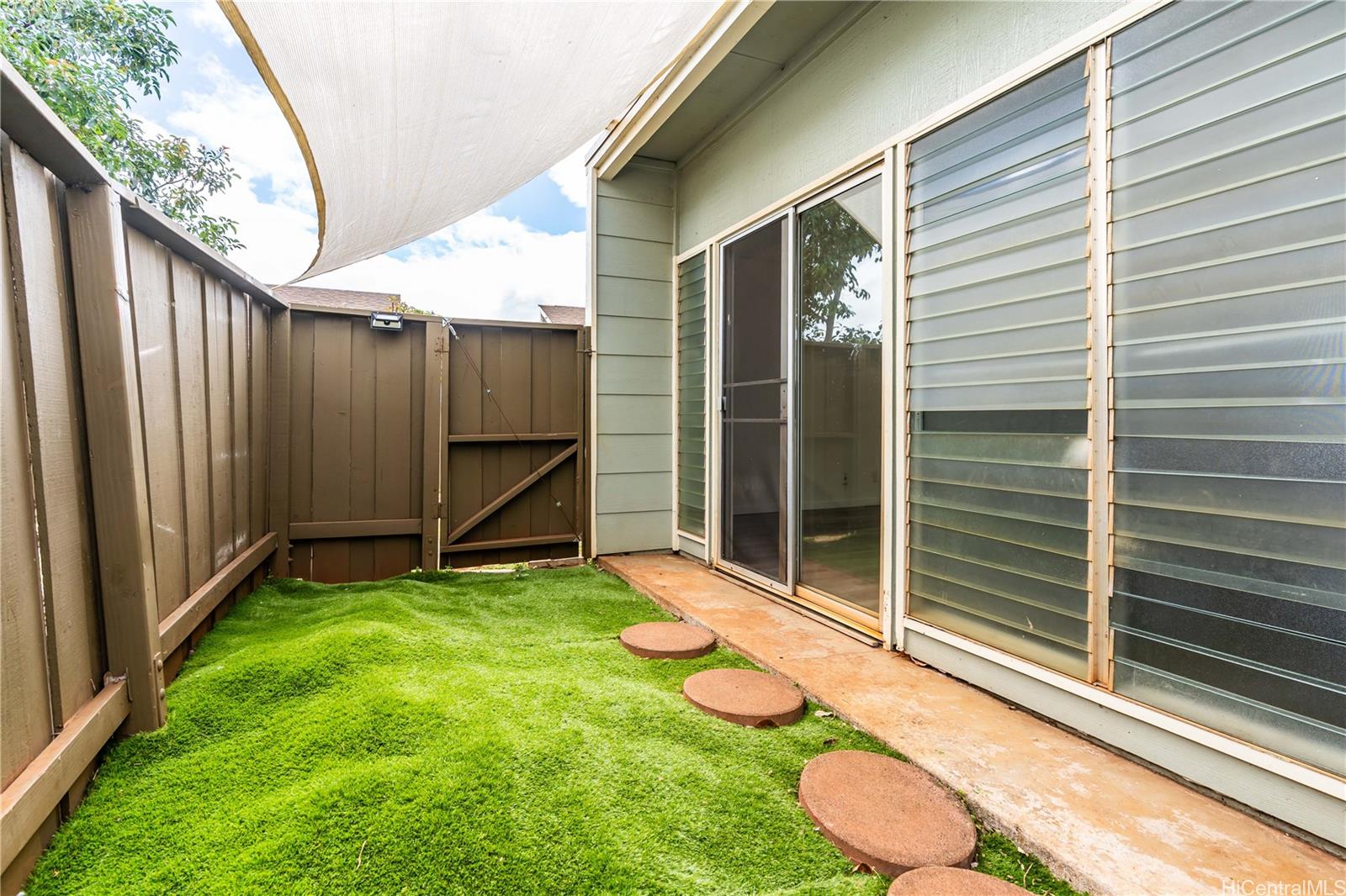 a view of a backyard with a backyard and stairs