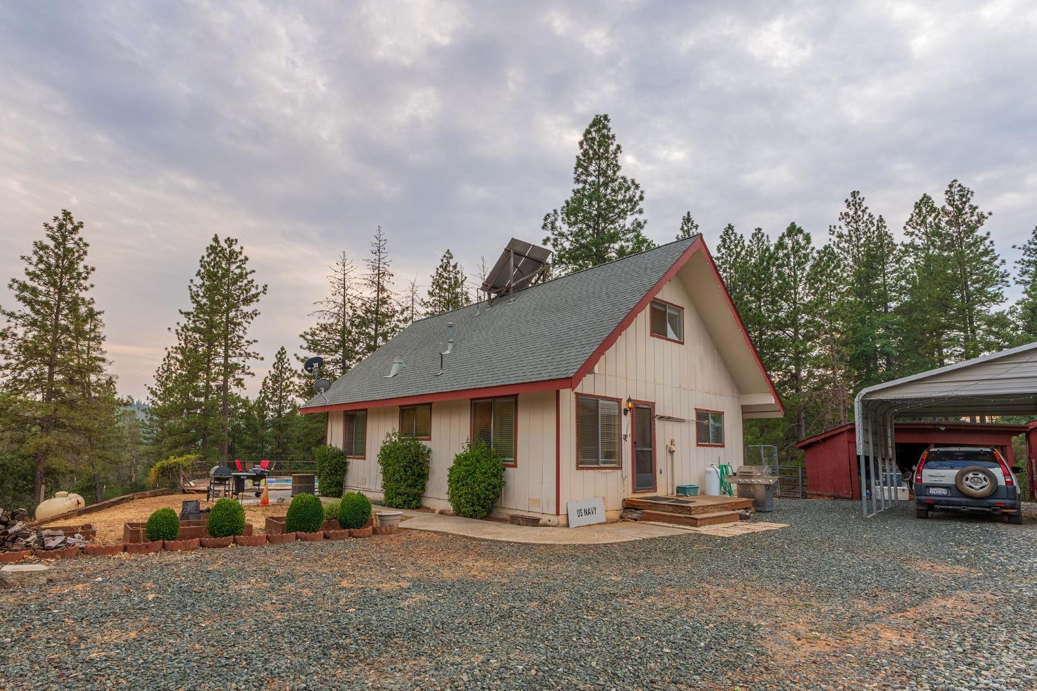 a view of a house with a patio and a yard