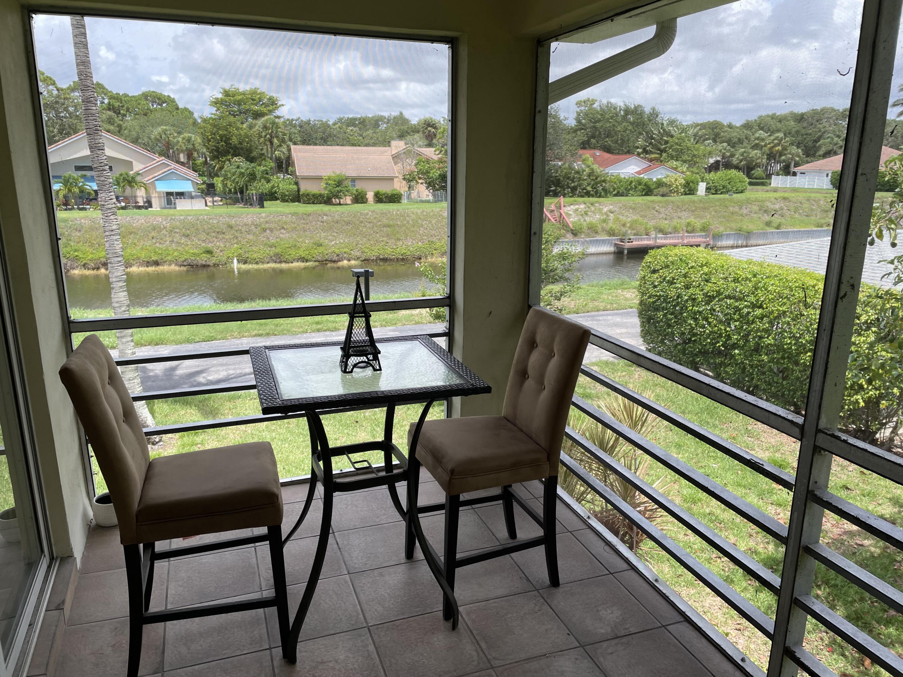 a view of a chairs and table in patio