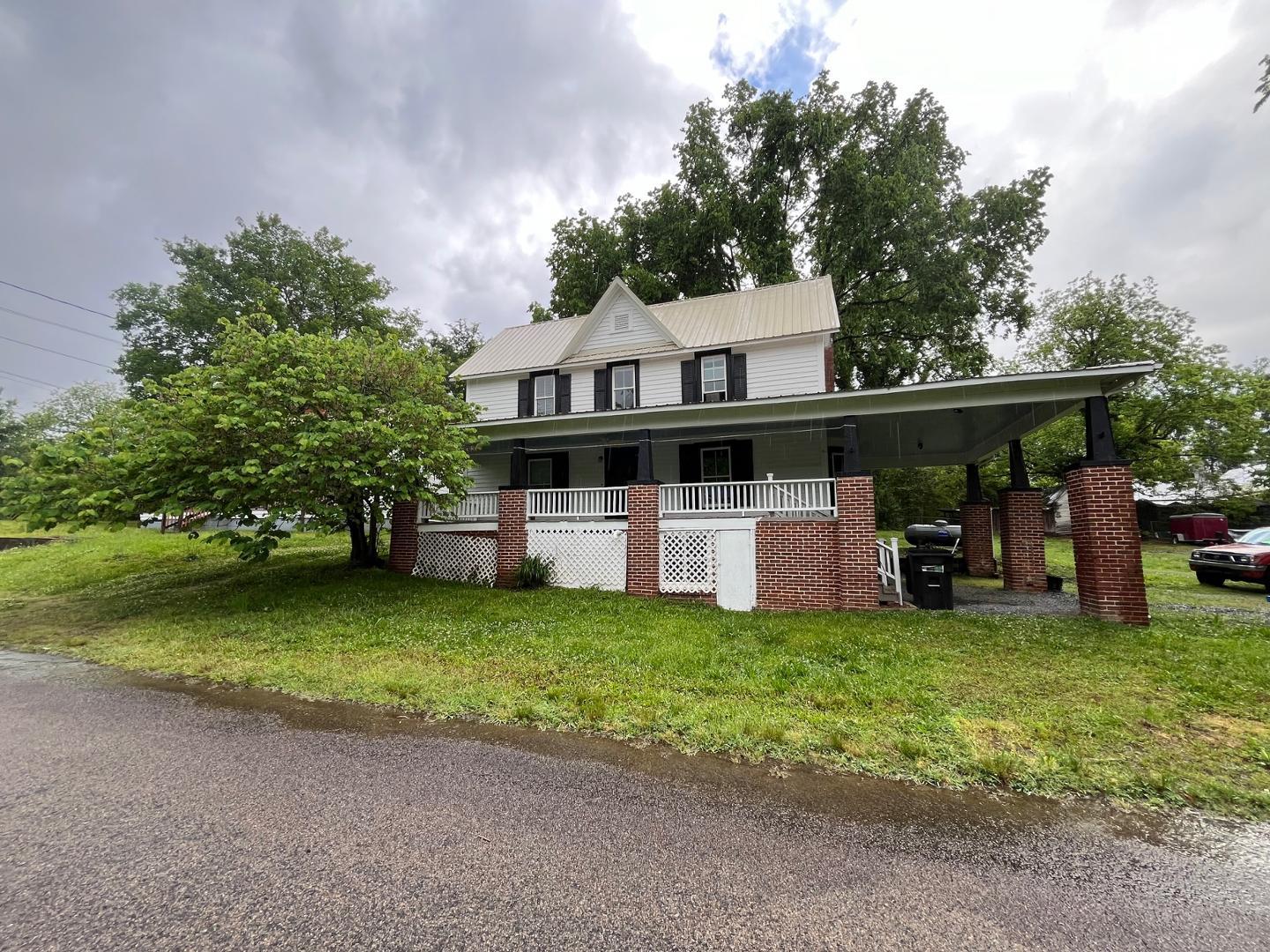 a view of a house with a yard porch and sitting area