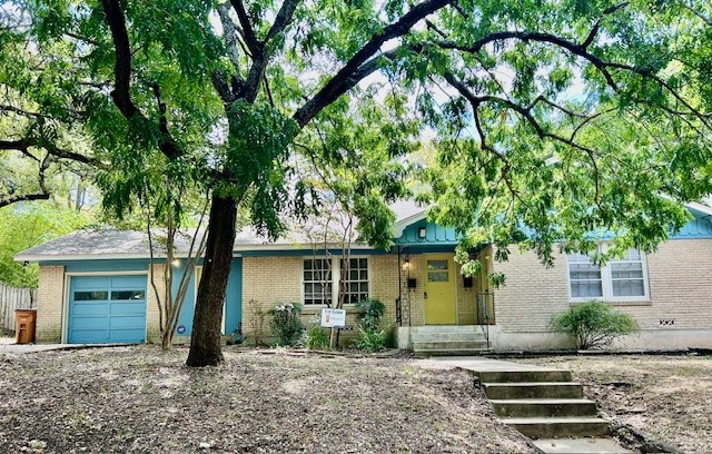 front view of a house with a tree in front of it