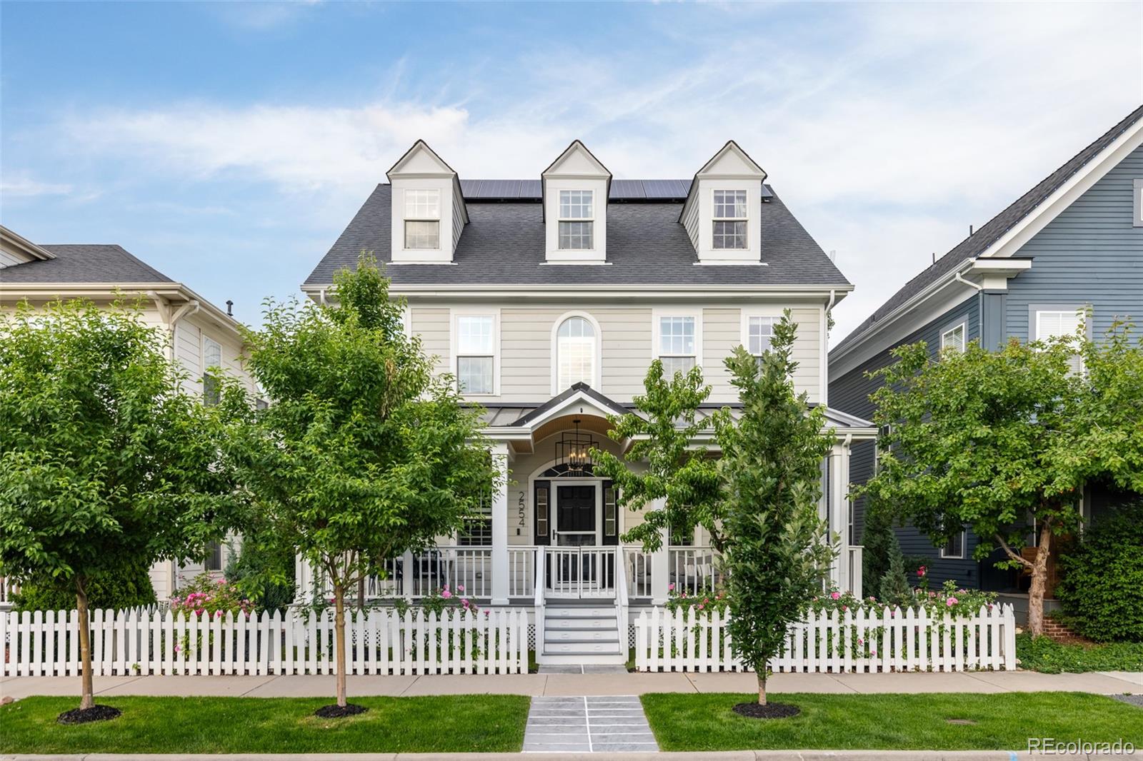 a front view of a house with a garden