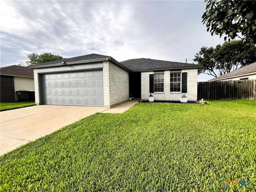 a front view of a house with yard and garage