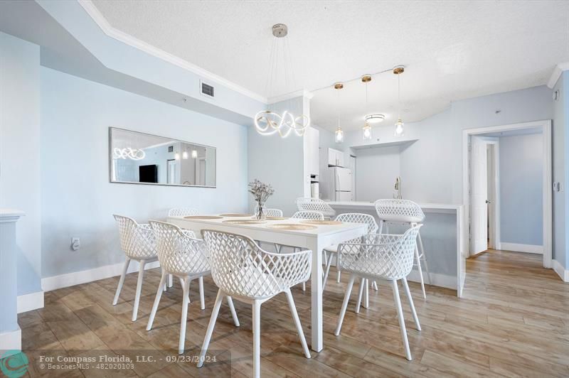 a view of a dining room with furniture and wooden floor