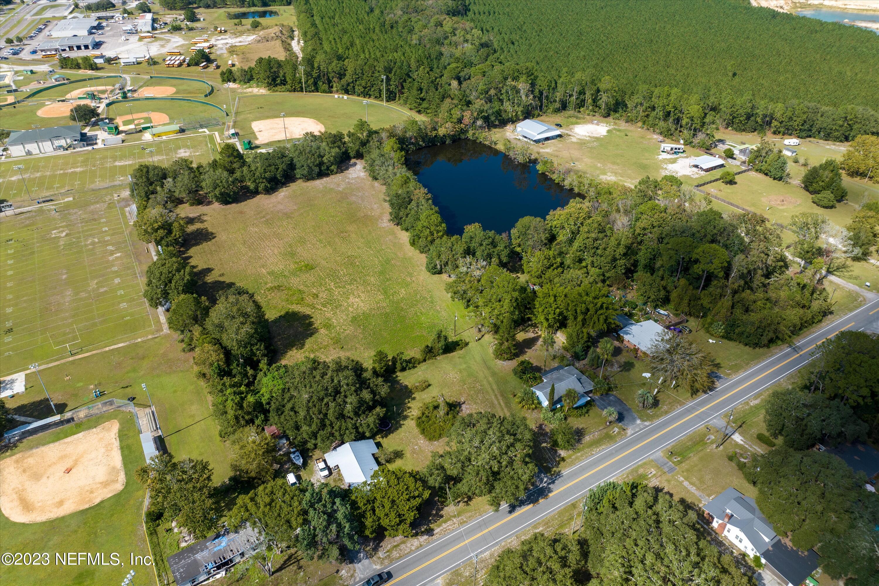 an aerial view of a residential houses with outdoor space