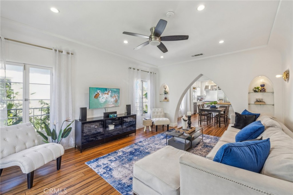 a living room with furniture and a wooden floor