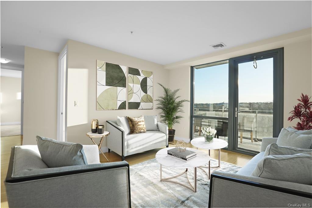 a living room with furniture and a floor to ceiling window