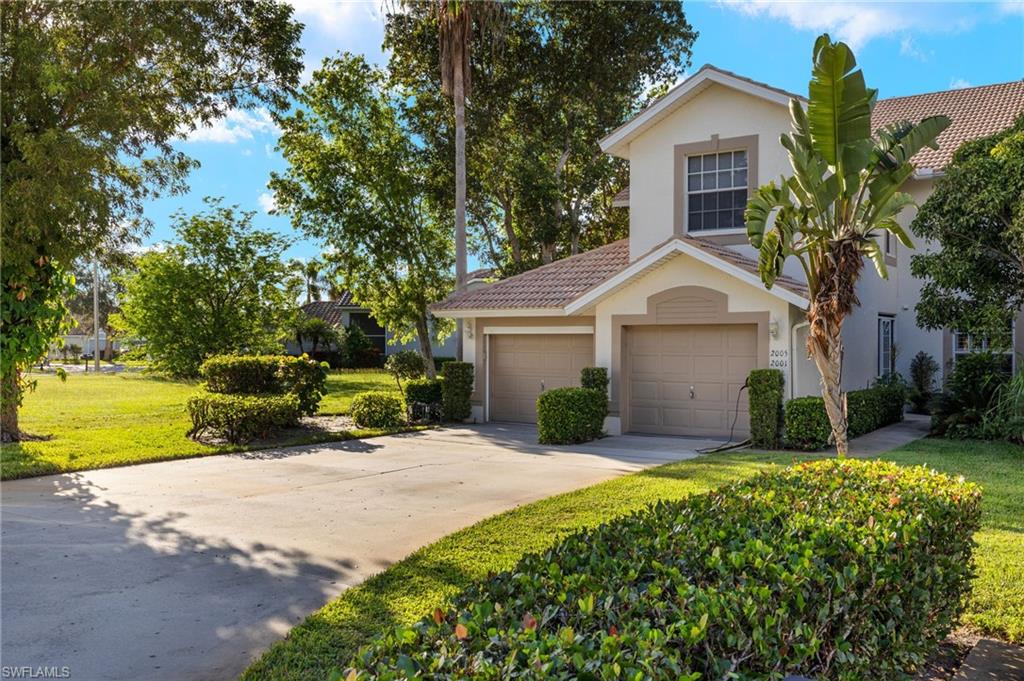 View of front of home with a front yard and a garage