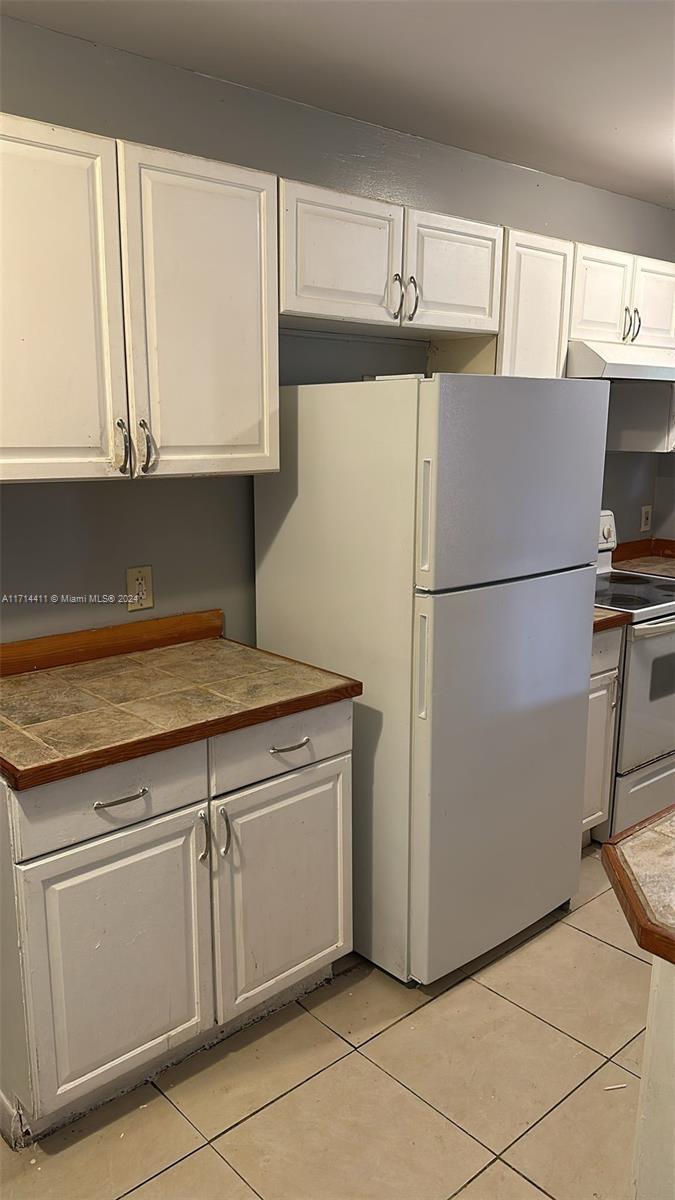 a white refrigerator freezer sitting inside of a kitchen