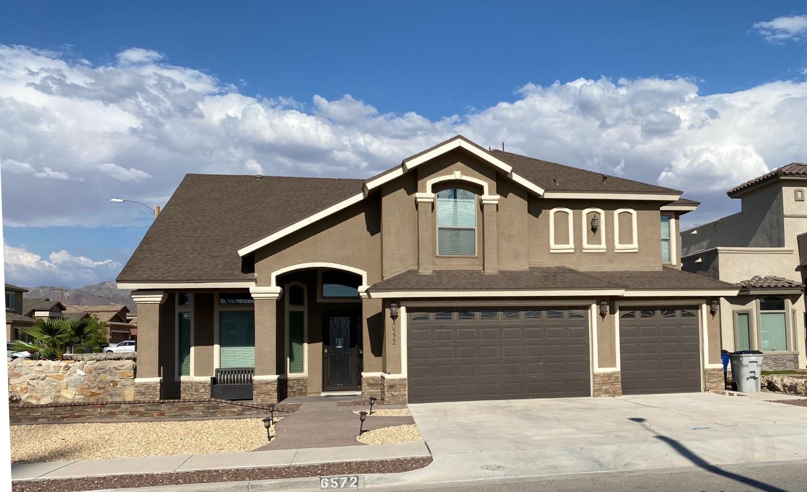 a front view of a house with yard