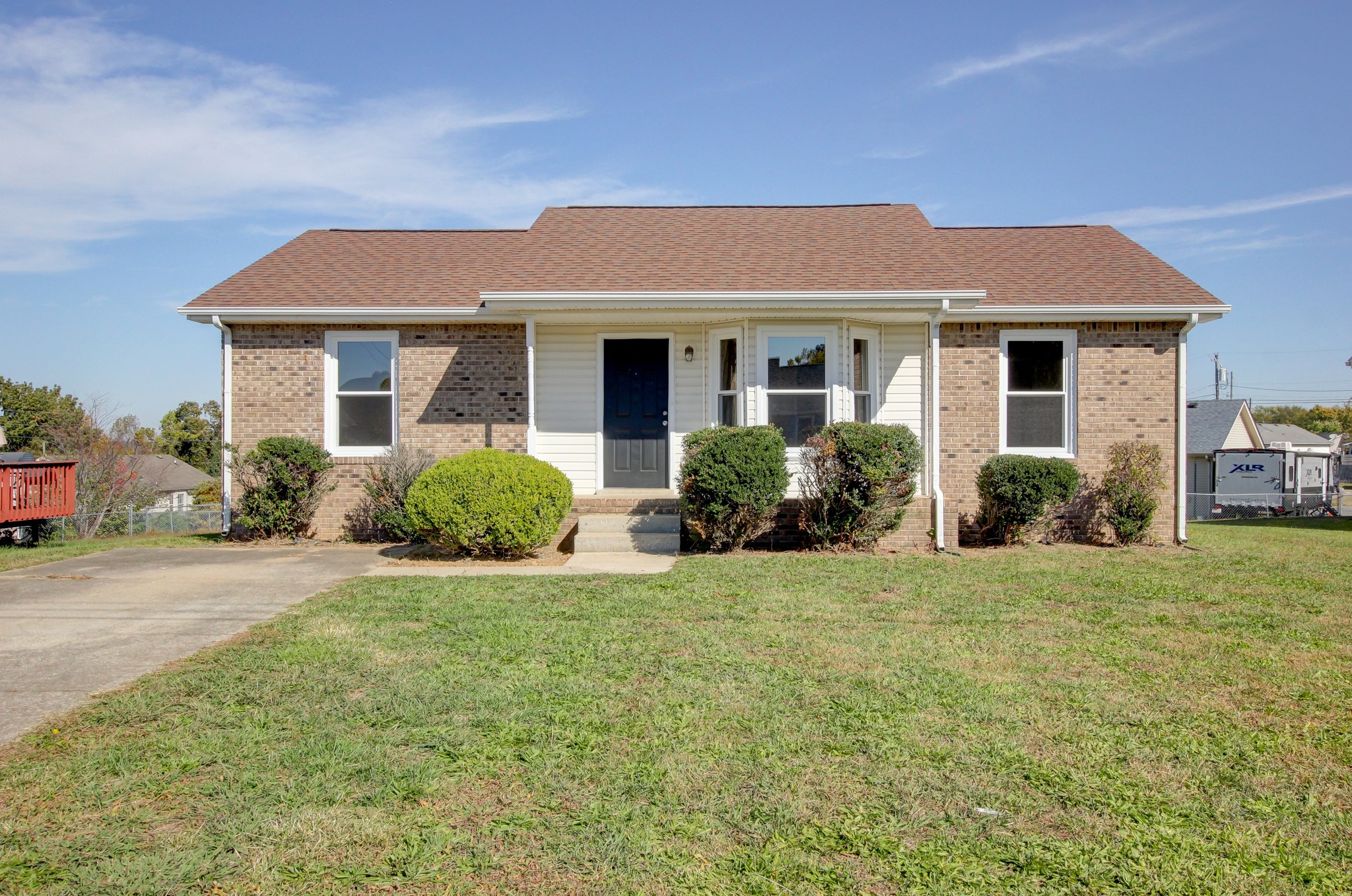 a front view of a house with a yard