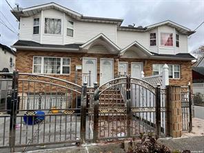 a front view of a house with iron fence