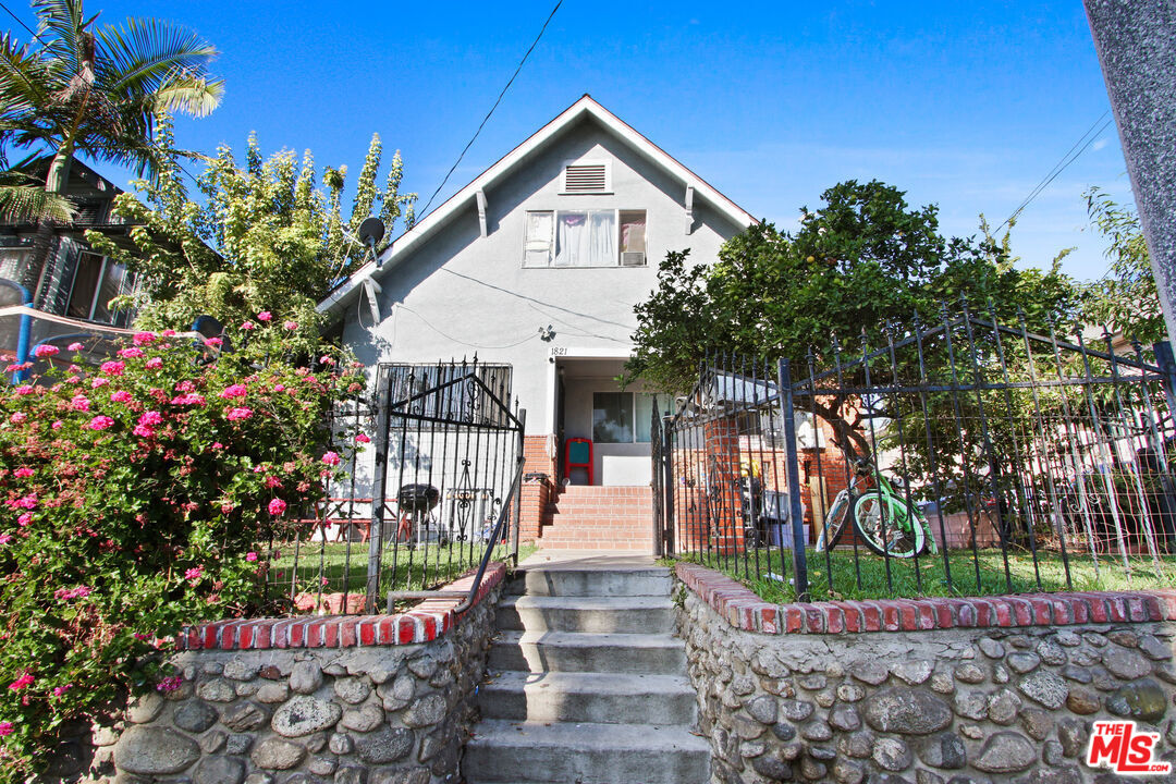 a front view of a house with a garden