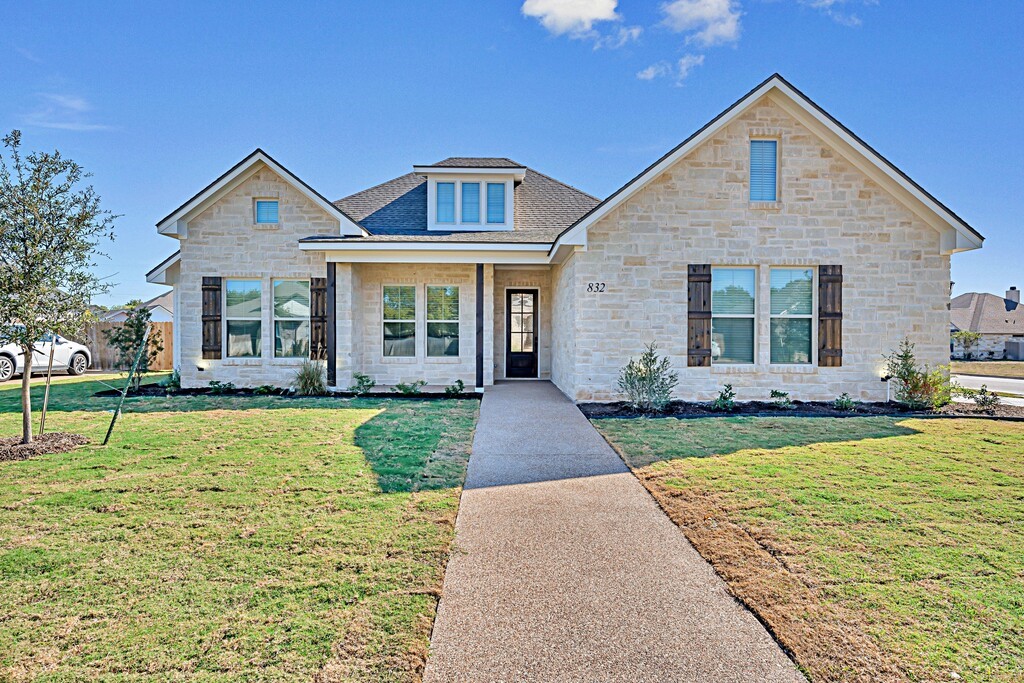 a front view of a house with a yard and porch