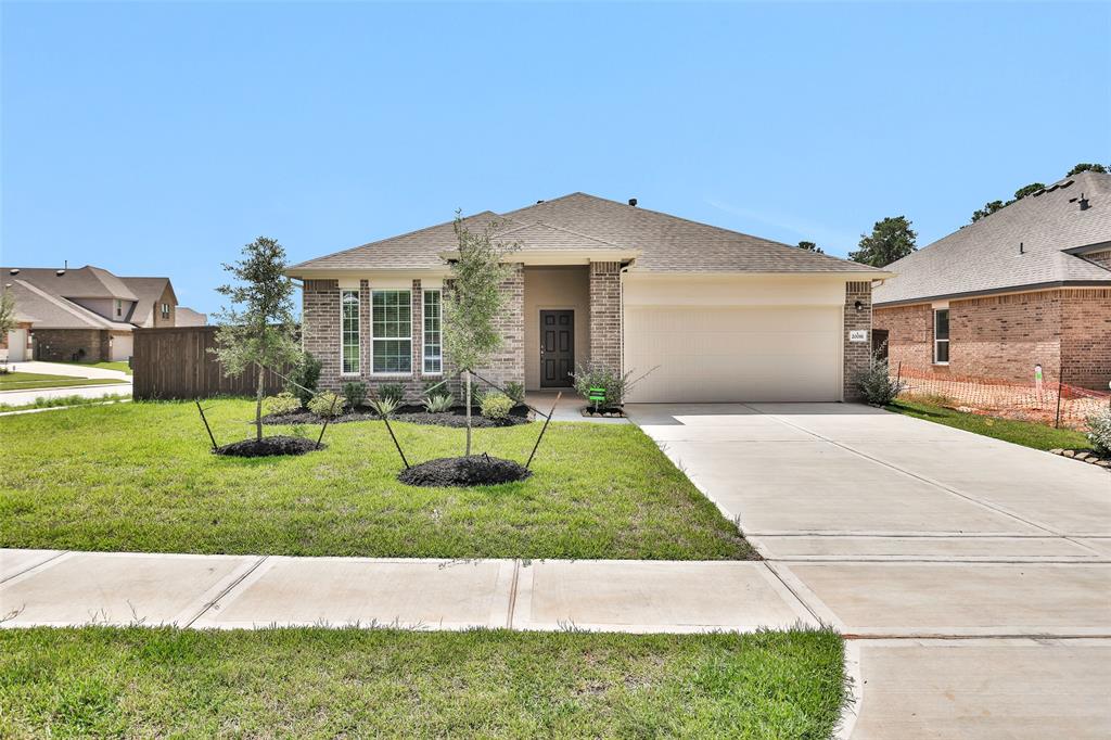 Welcome to your new home! This newly built property boasts a stylish facade with a mix of modern and traditional design elements. The well-manicured front lawn and inviting entryway create a warm first impression.