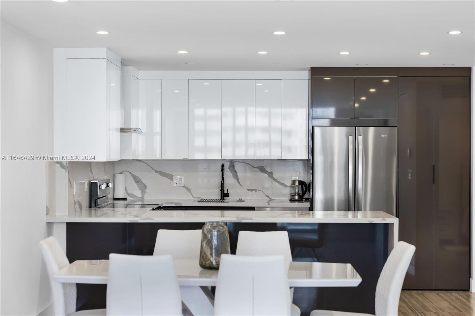 a kitchen with a table and chairs in it