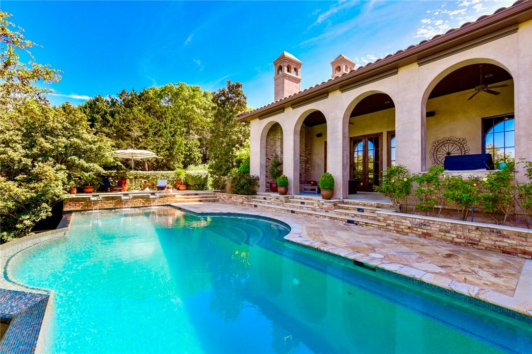 a swimming pool with outdoor seating and yard