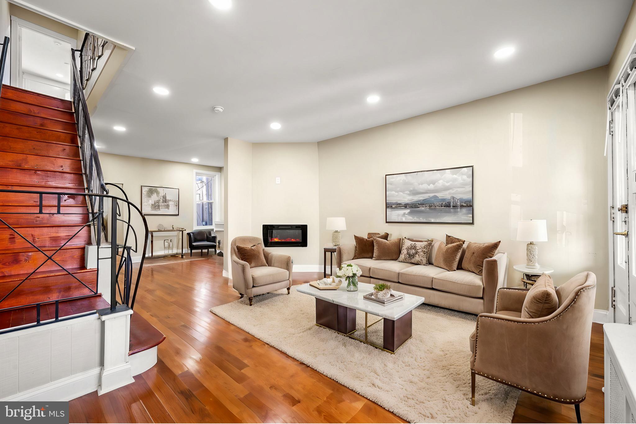 a living room with furniture wooden floor and a flat screen tv