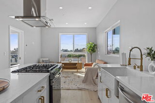 a kitchen with a sink and a stove top oven