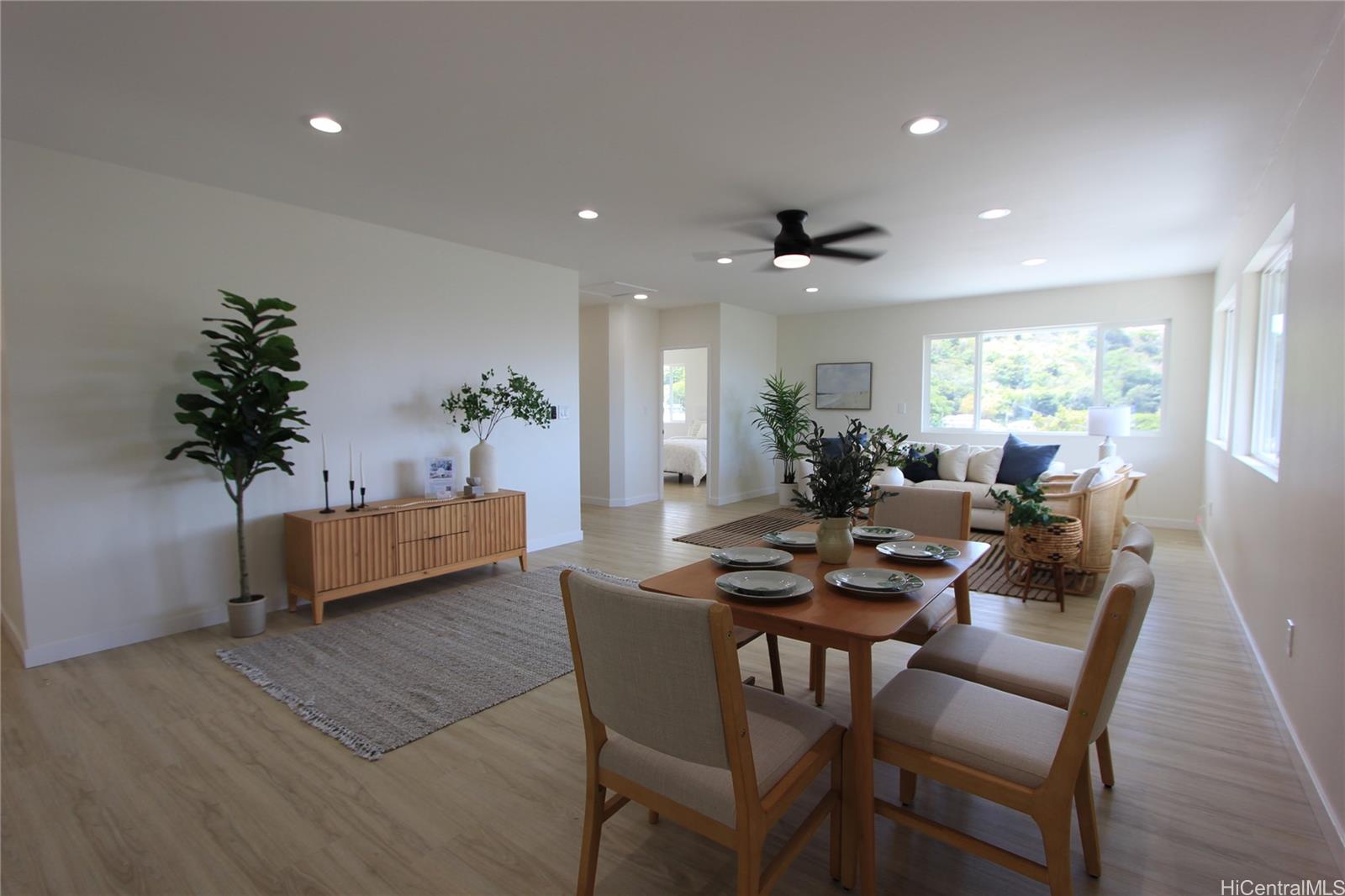 a view of a dining room with furniture and a potted plant