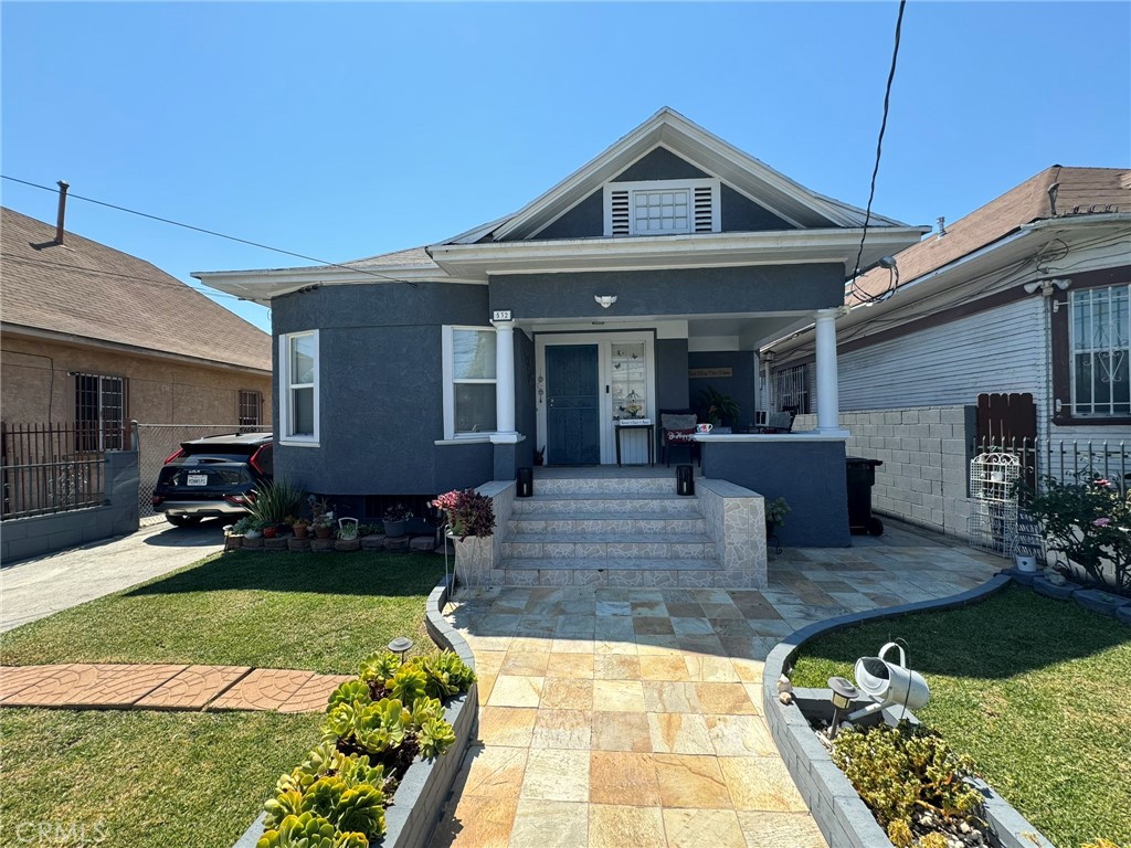 a front view of a house with garden