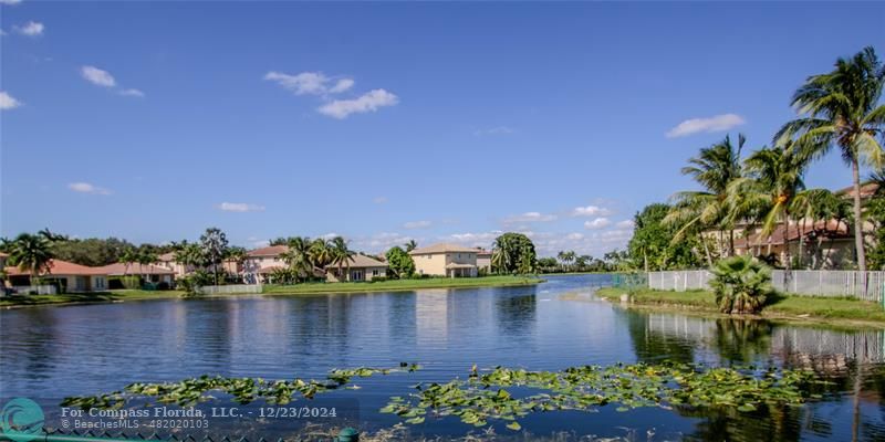 a view of a lake with a house in the background