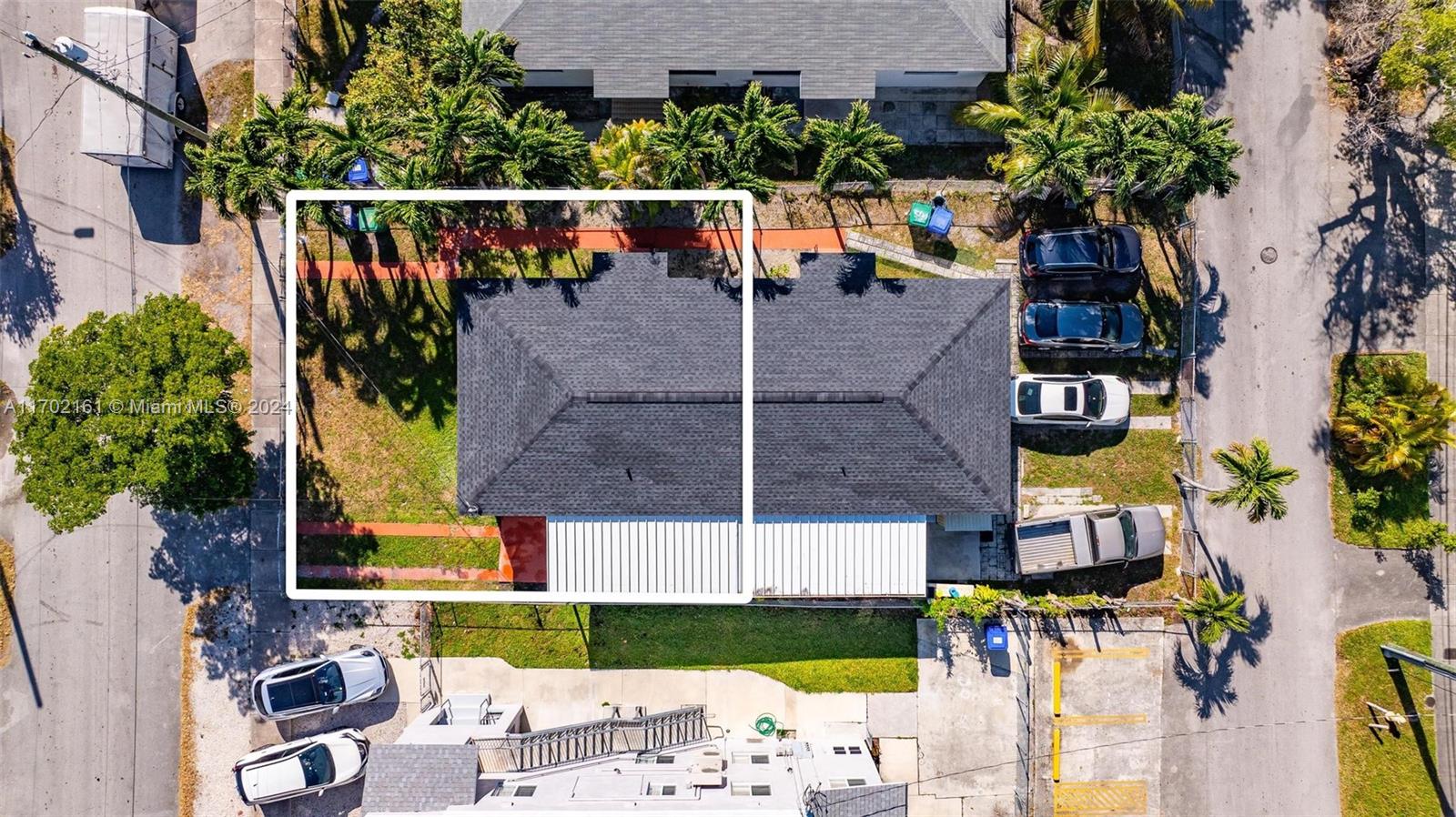 an aerial view of a house with a garden and swimming pool