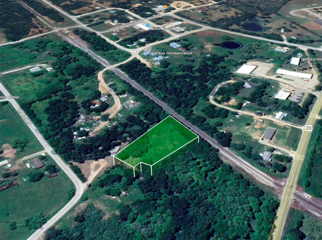 an aerial view of a residential houses with outdoor space and street view