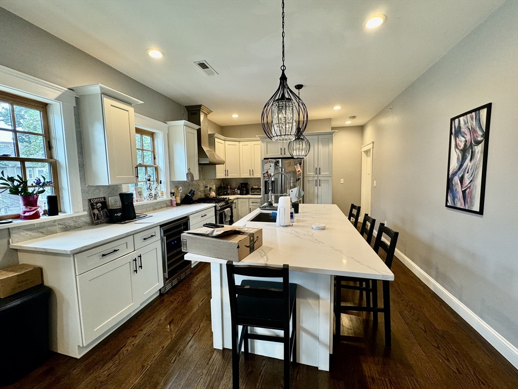 a large kitchen with a table and chairs