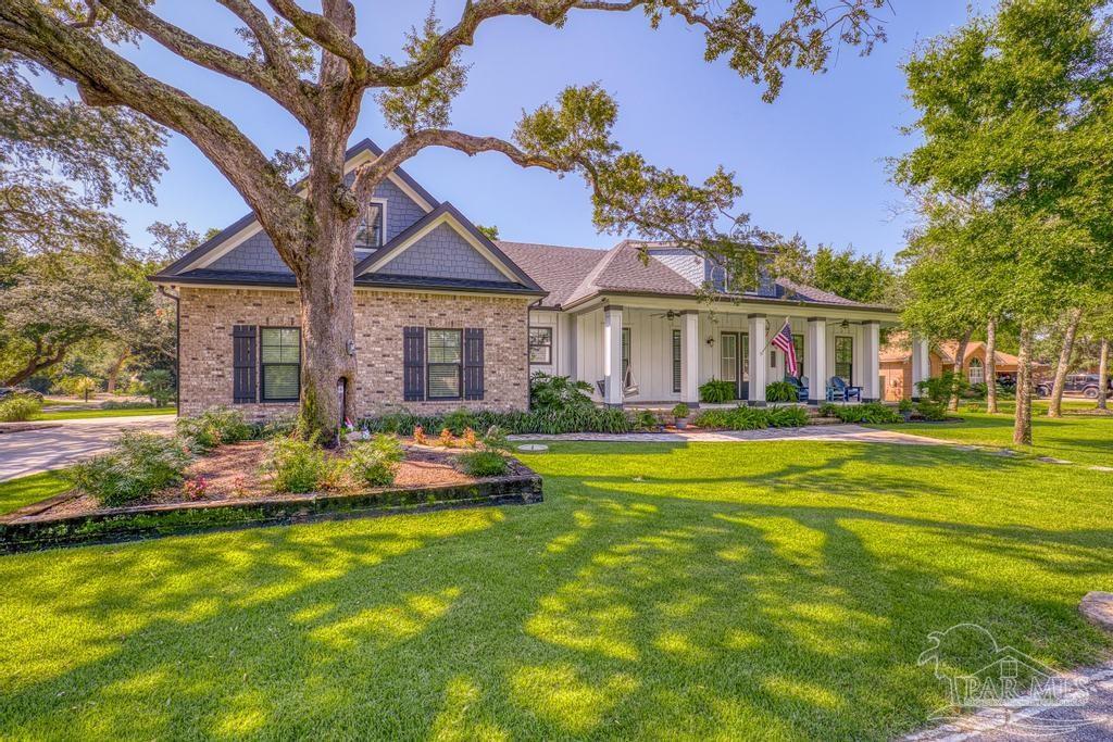 a front view of house with yard and swimming pool